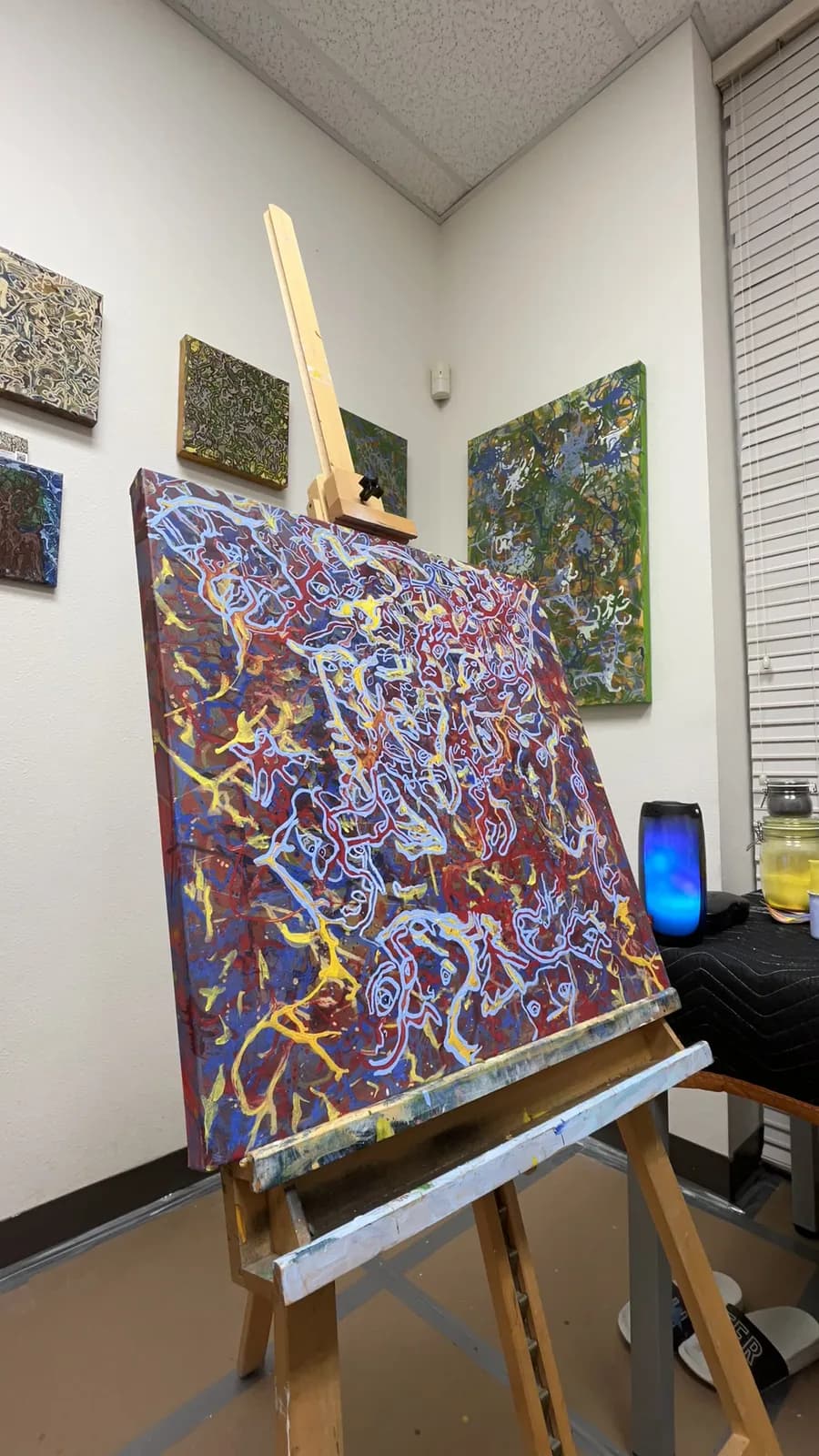 A painting in natural pigments on an easel in Ana Violeta's studio